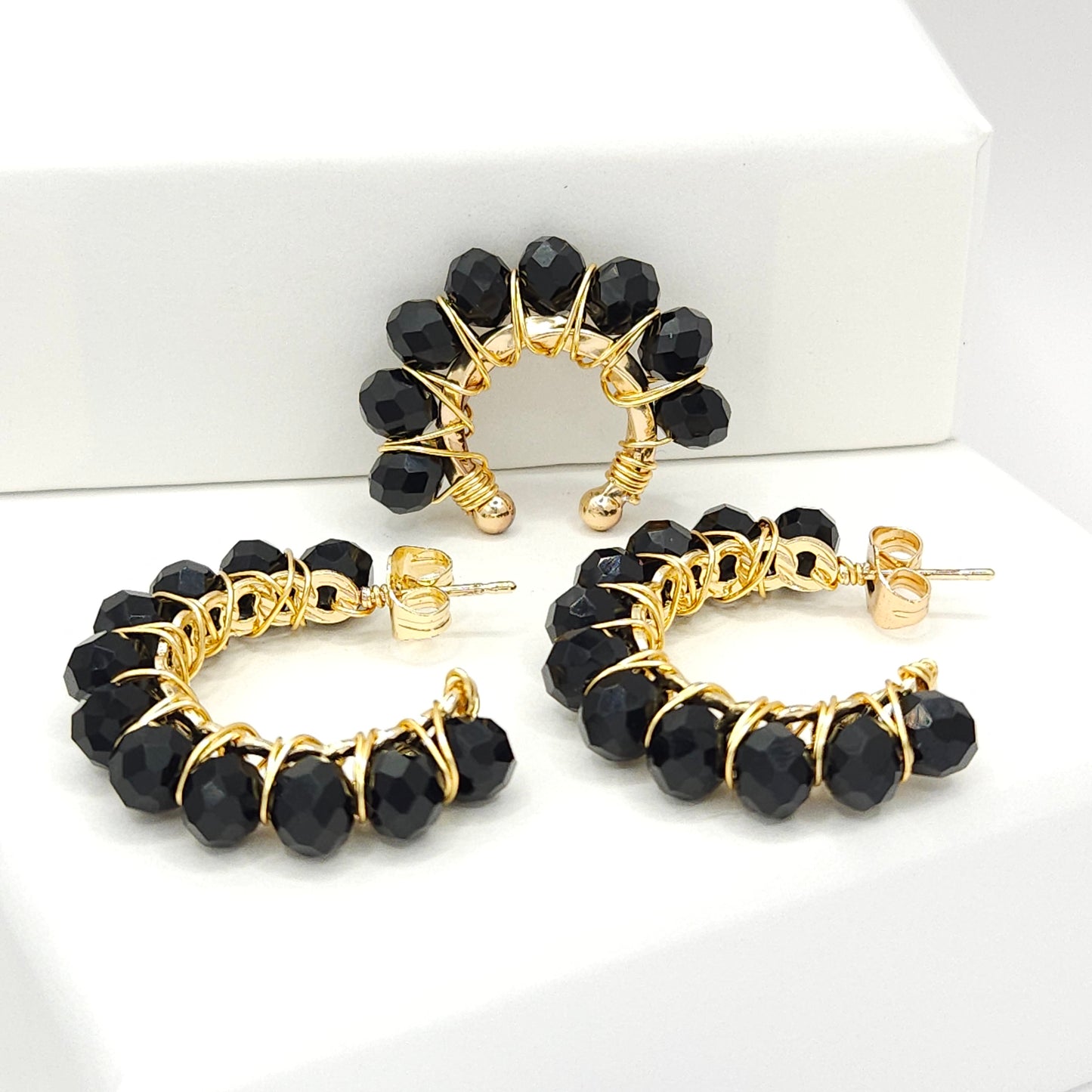 Golden pair of hoops and ear cuff with delicate black faceted rondelle glass beads