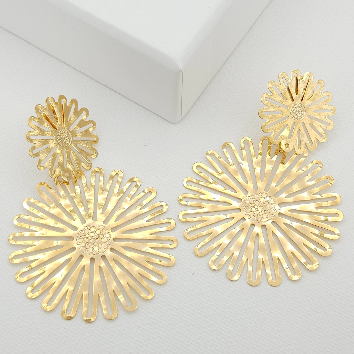 Handmade 18k gold plated bronze statement earrings featuring a small flower at the top and a larger blossom below