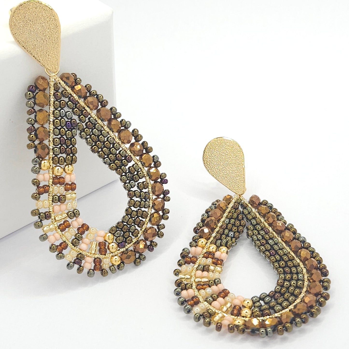 Teardrop-shaped handmade statement artisanal earrings made of chocolate Czech beads and Metal coated in goldtone finish
