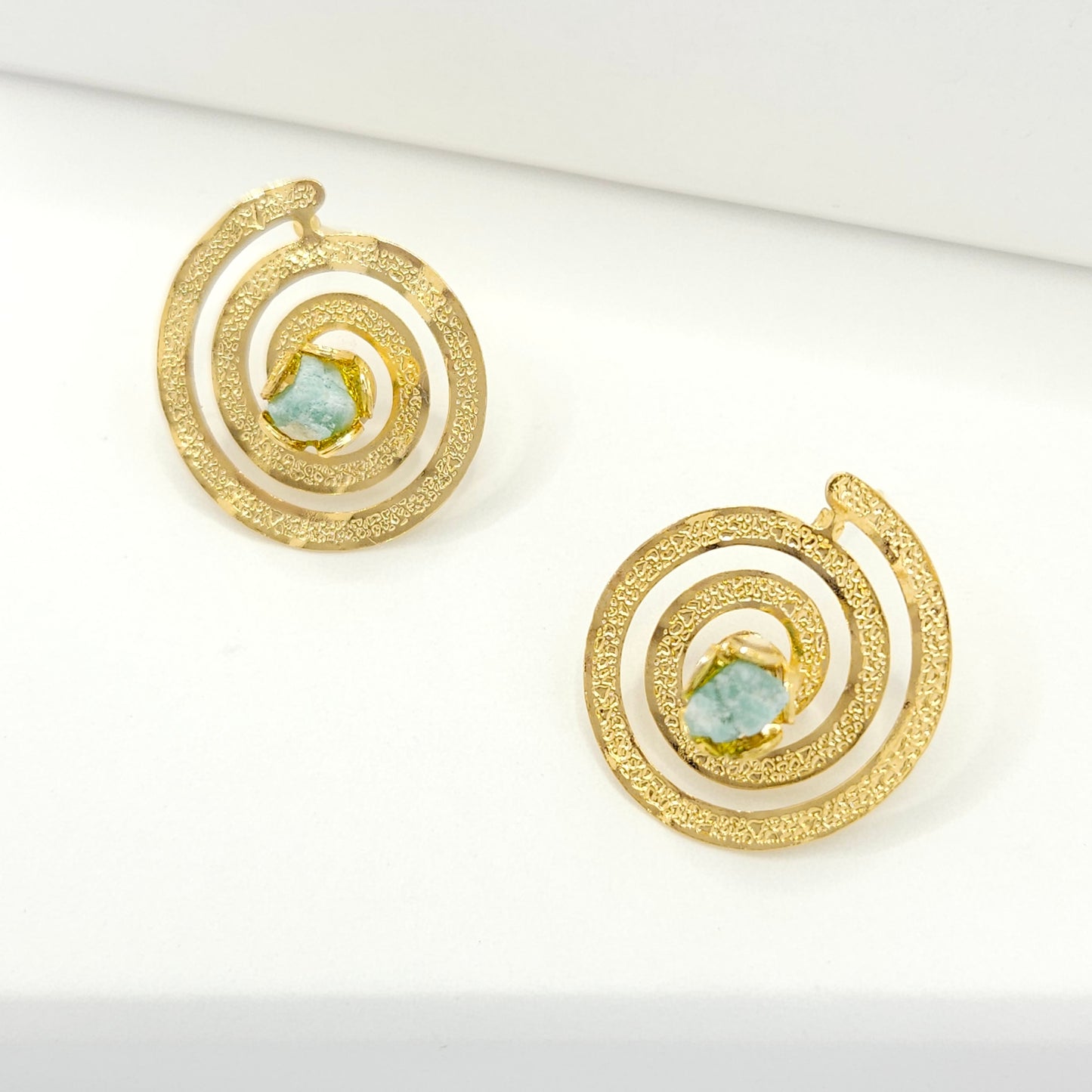 Handmade spiral statement earrings from luxurious 18k gold-plated bronze and Emerald murralla