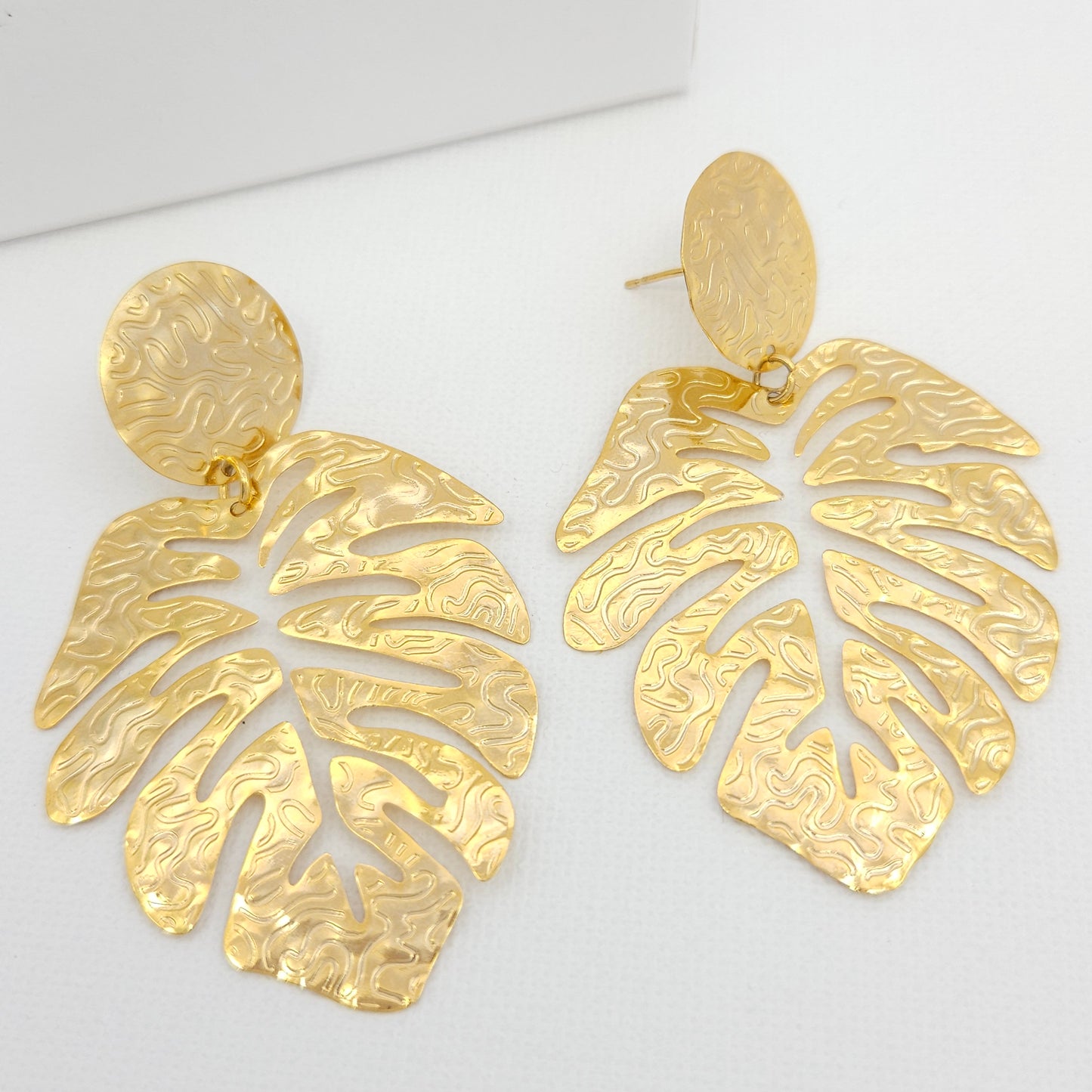 Handmade 18k gold plated bronze statement earrings showcasing the delicate contours of a leaf