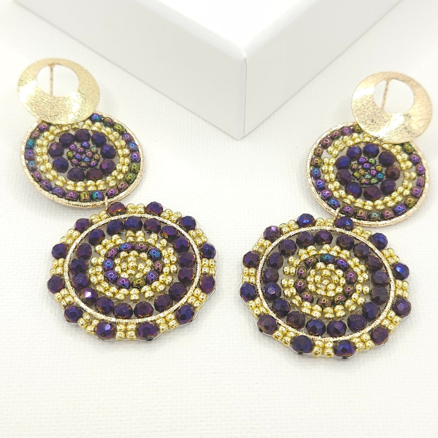 Statement artisanal earrings featuring two dangling suns with a blend of purple palatinate Czech beads and golden Rondelle beads