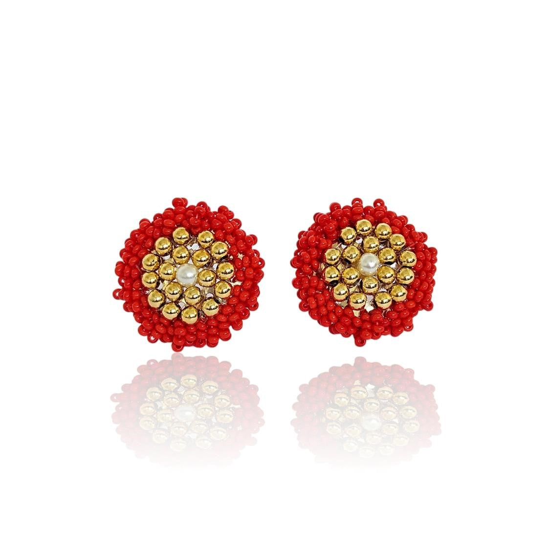 Large stud earrings with a round shape, adorned with red Czech beads, goldtone spheres, and a pearl at their centre