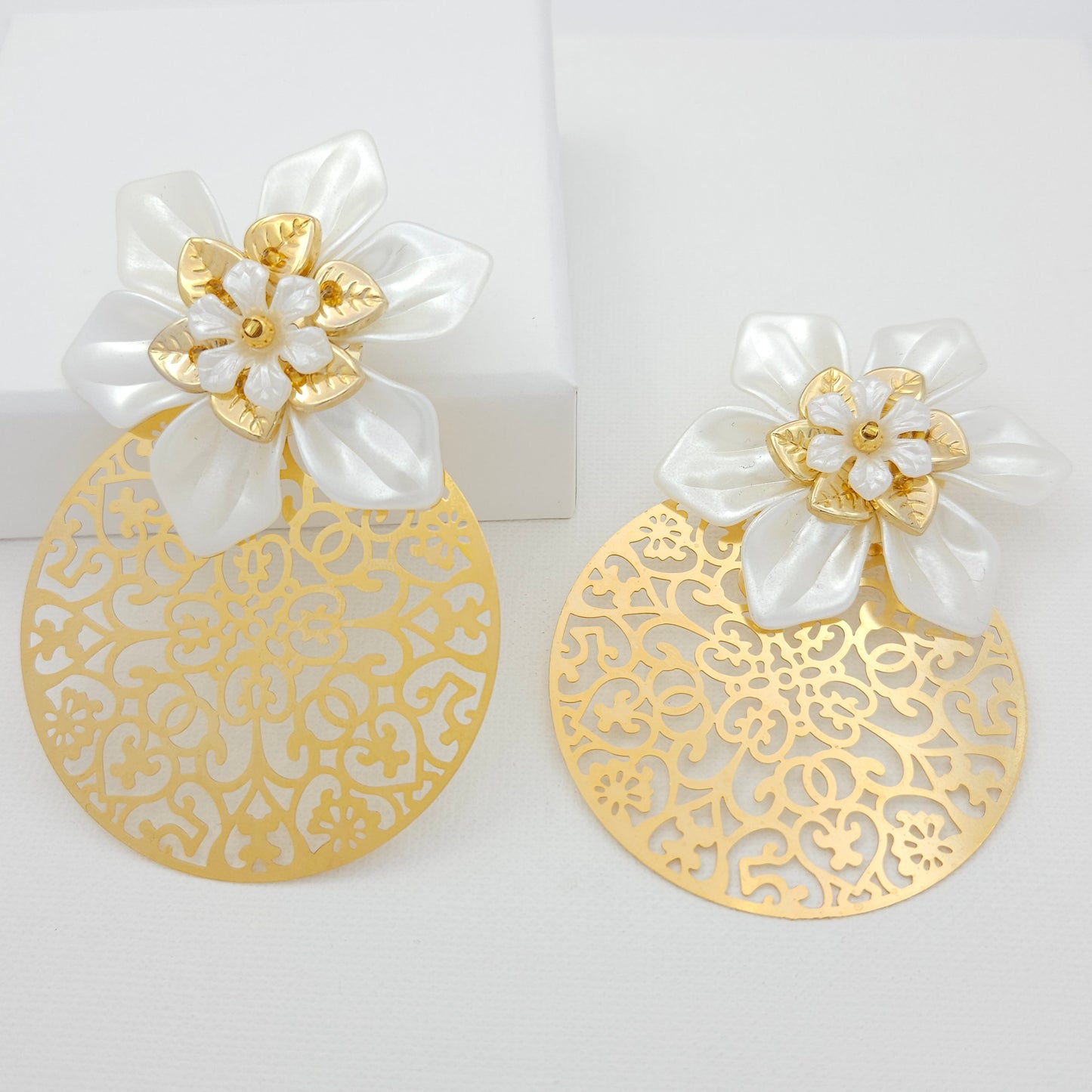 Handmade 18k gold plated bronze statement earrings with a circular design and a white flower at the top