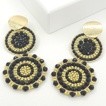Statement artisanal earrings featuring two dangling suns with a blend of black Czech beads and golden Rondelle beads