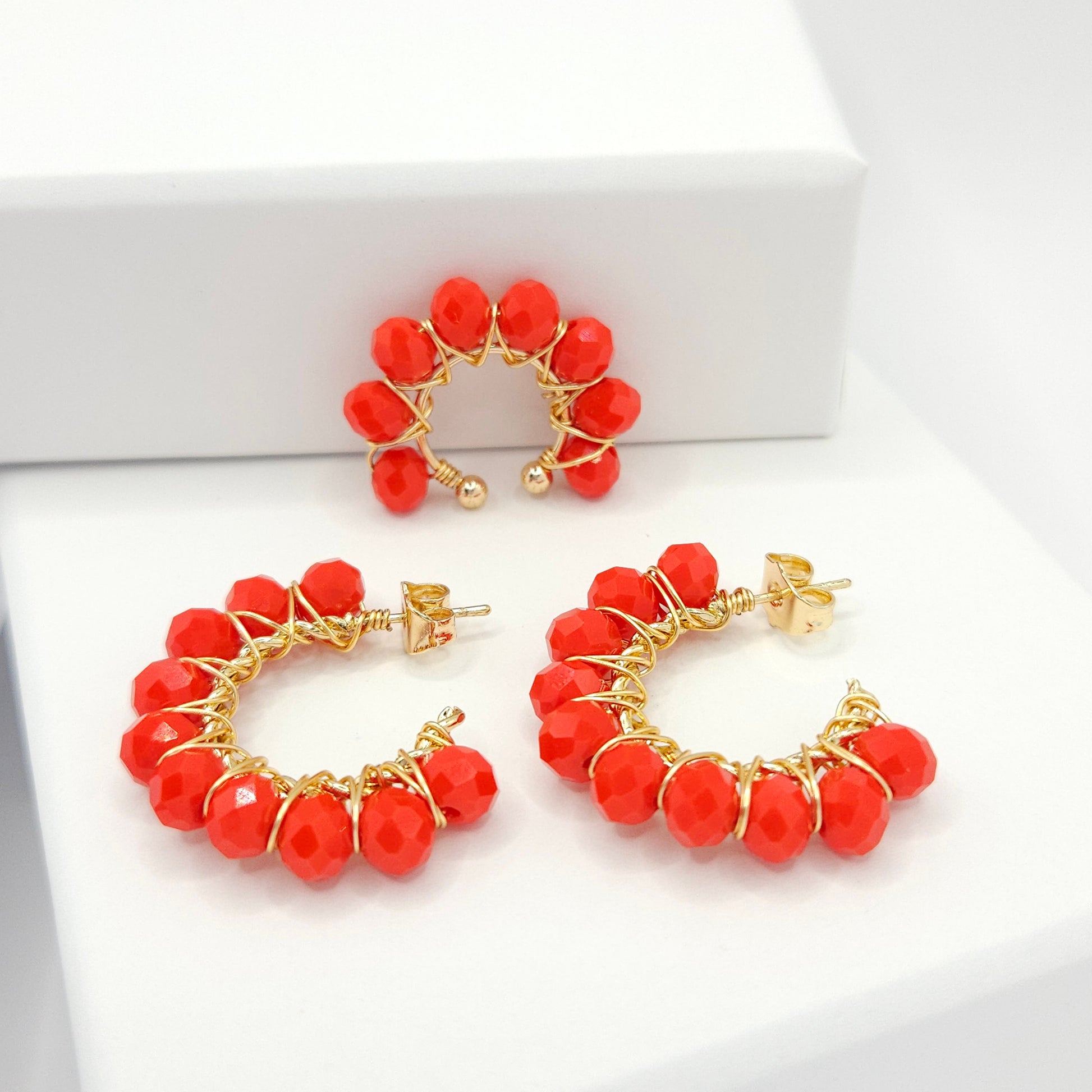 Golden pair of hoops and ear cuff with delicate red faceted rondelle glass beads